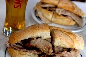 bifana portuguese pork sandwich as street food with beer sagres portugal